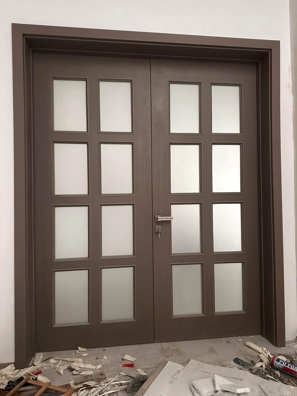 Double entrance door with geometric glazed panel design