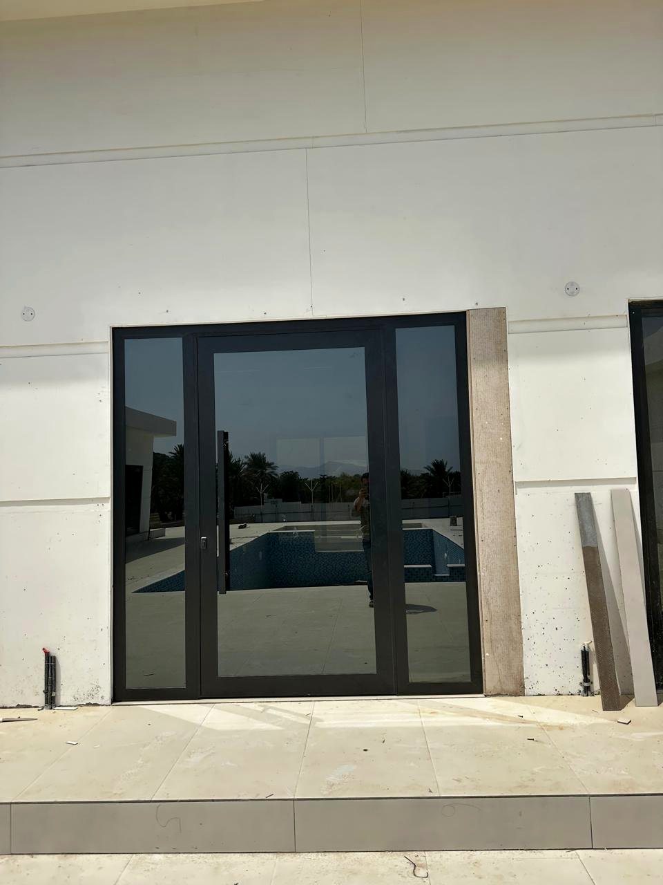 Black framed double entrance door at a villa