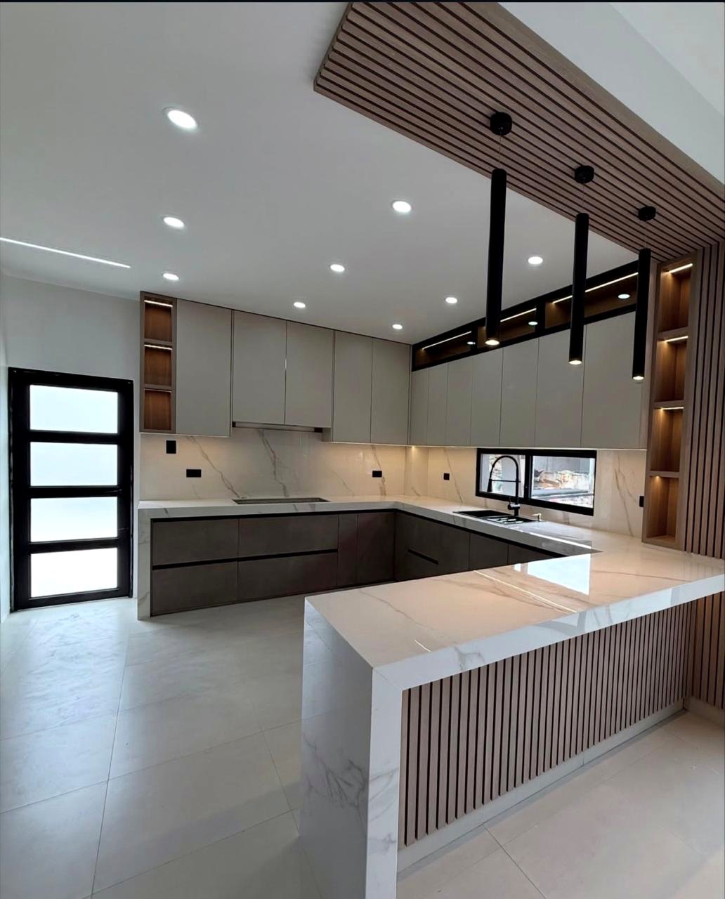 Custom grey kitchen with island and integrated lighting in Fujairah