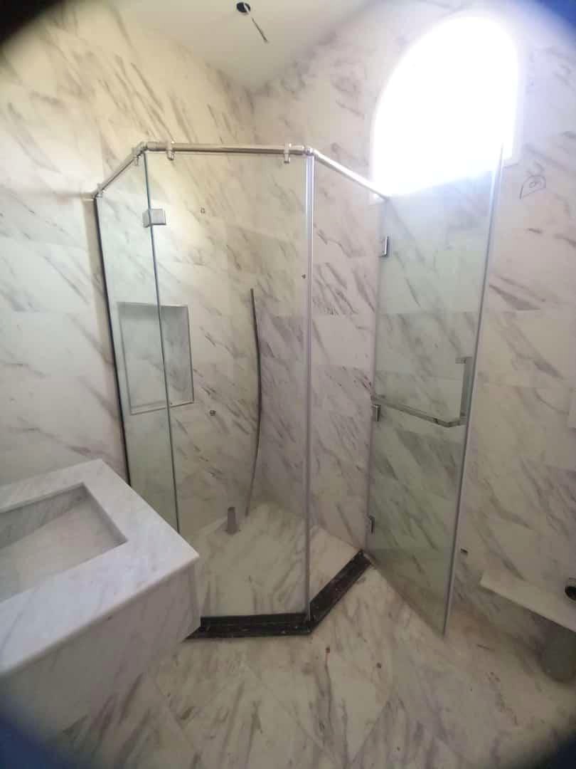 Custom clear shower glass in a marble bathroom