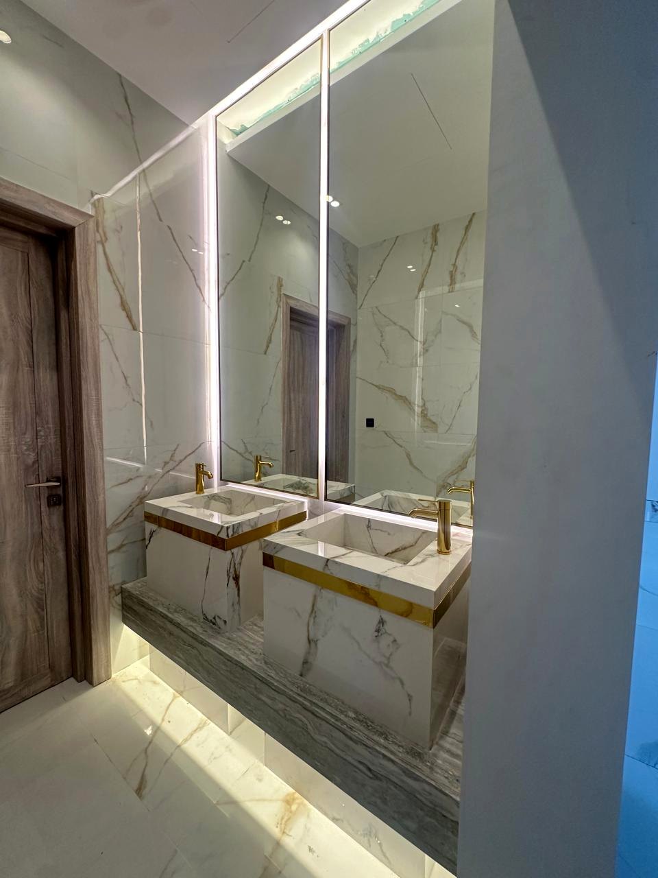 Light marble double vanity with full height mirrors